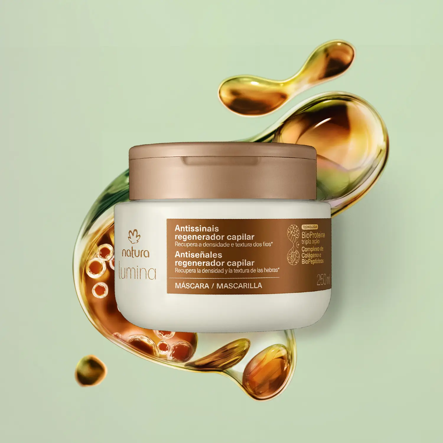 frasco da Natura Lumina Antissinais Regenerador Capilar – Máscara 250 ml em destaque, sobre fundo verde com textura fluida que remete à BioProteína